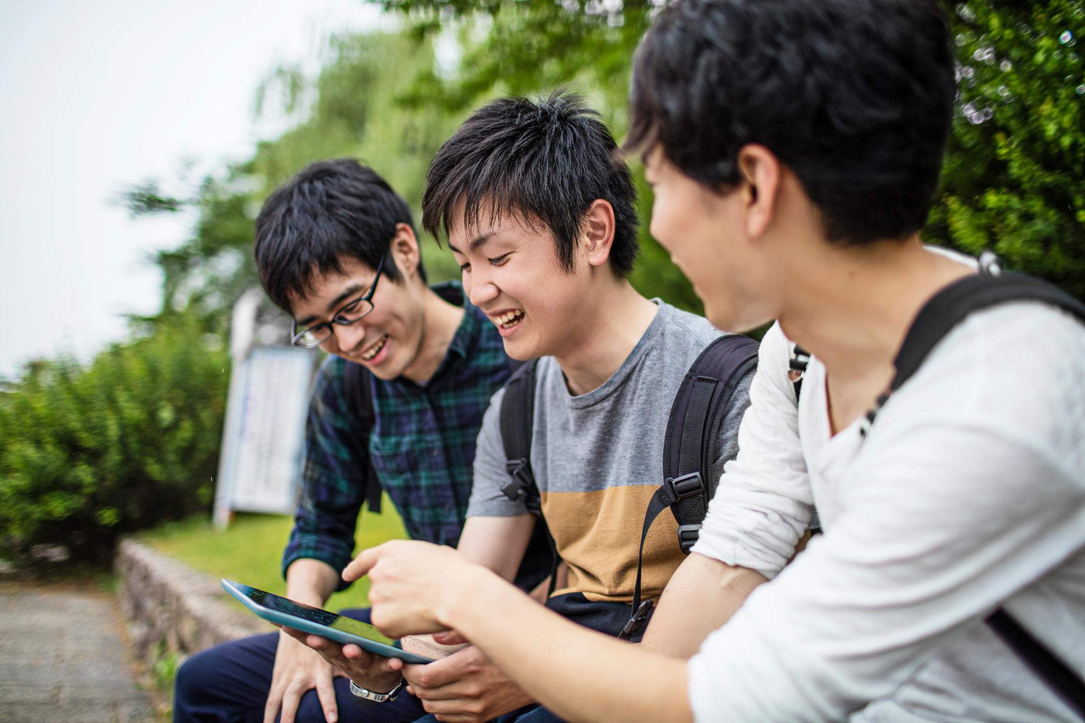 students sitting on ledge chatting